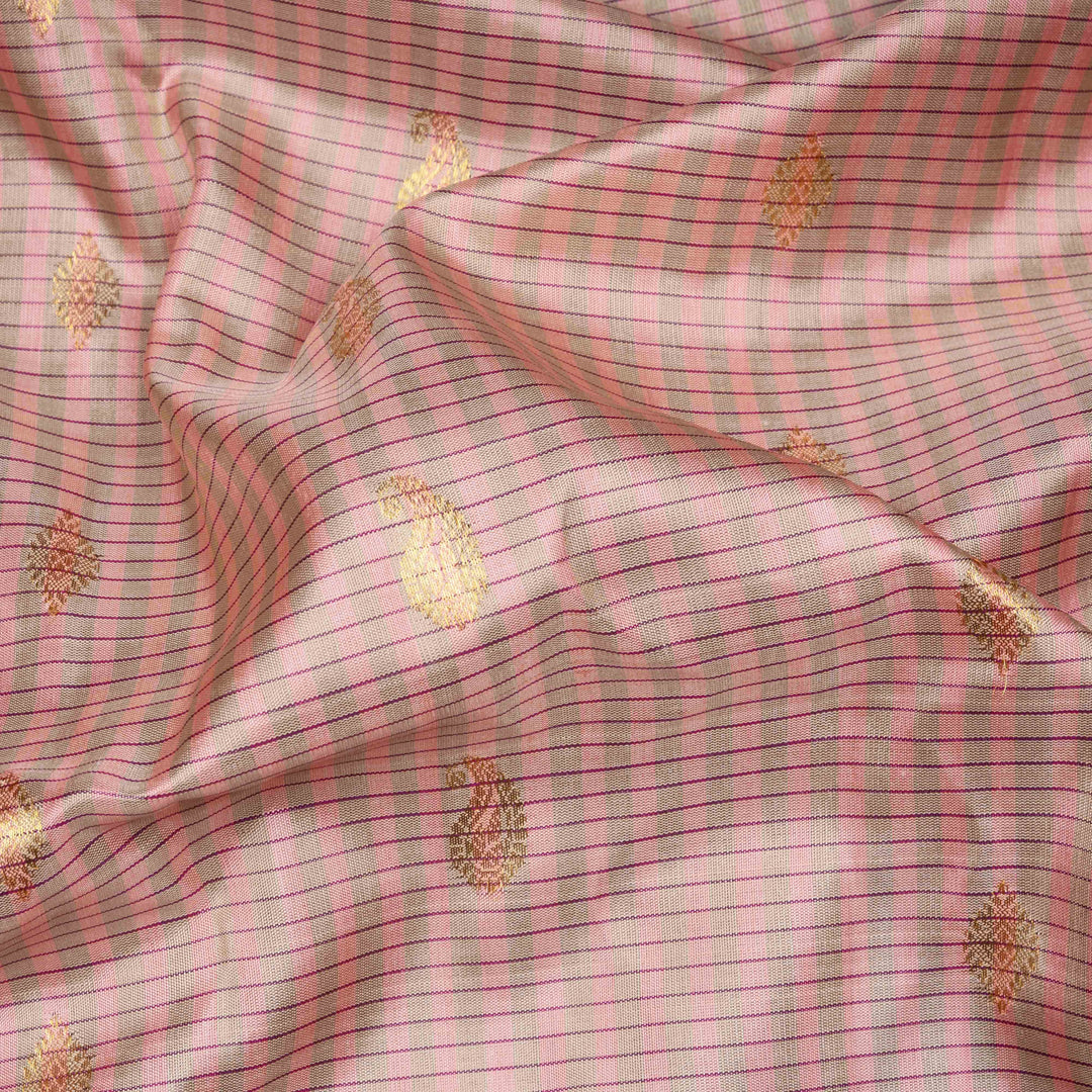Peach Gadwal silk saree with grey checks and small butta body, purple zari border with mango and leaf motifs, plain purple blouse.