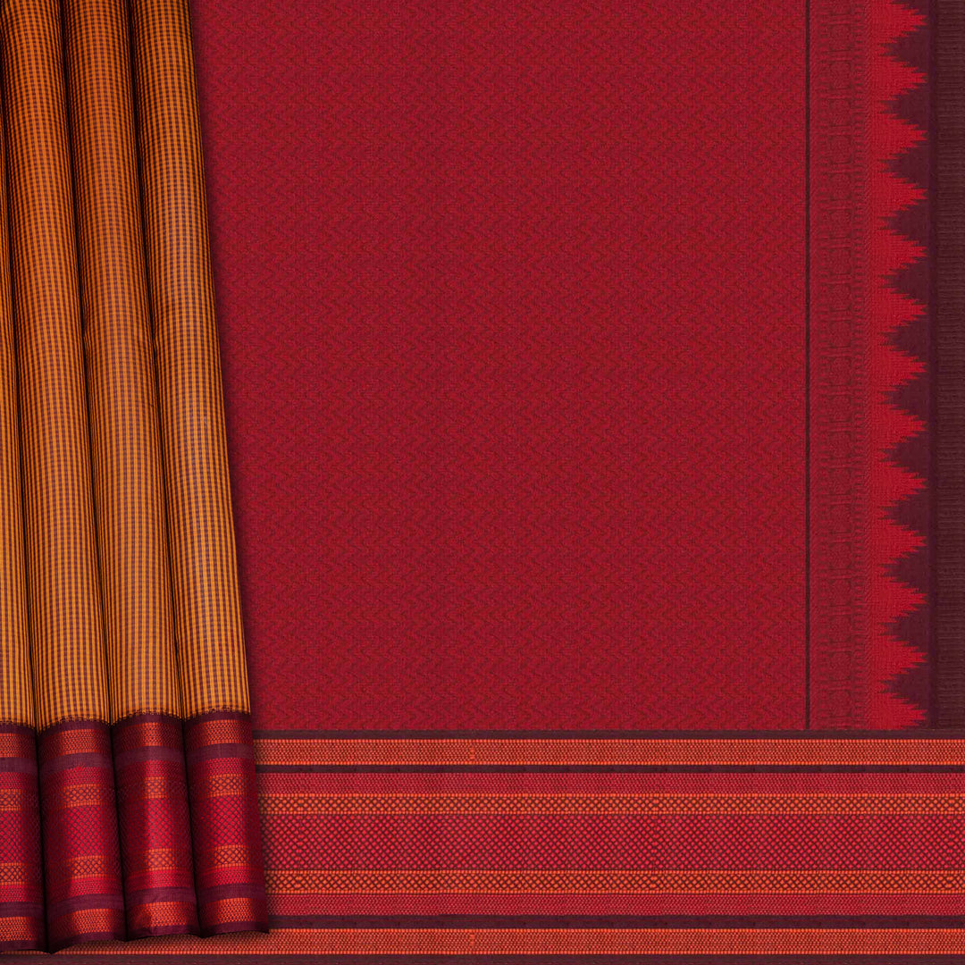 Mustard Gadwal silk saree with brown micro checks body, contrasting woven border with stripes and diamond patterns, brown pallu with temple motifs.