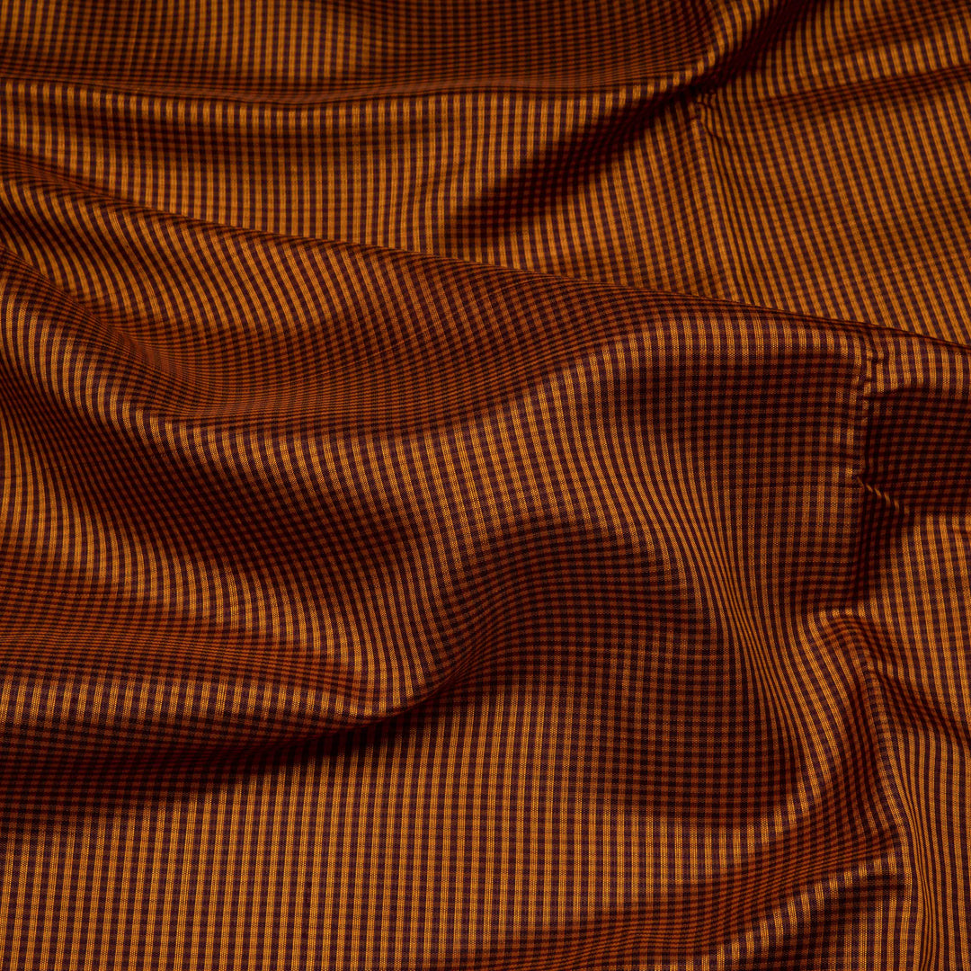 Mustard Gadwal silk saree with brown micro checks body, contrasting woven border with stripes and diamond patterns, brown pallu with temple motifs.