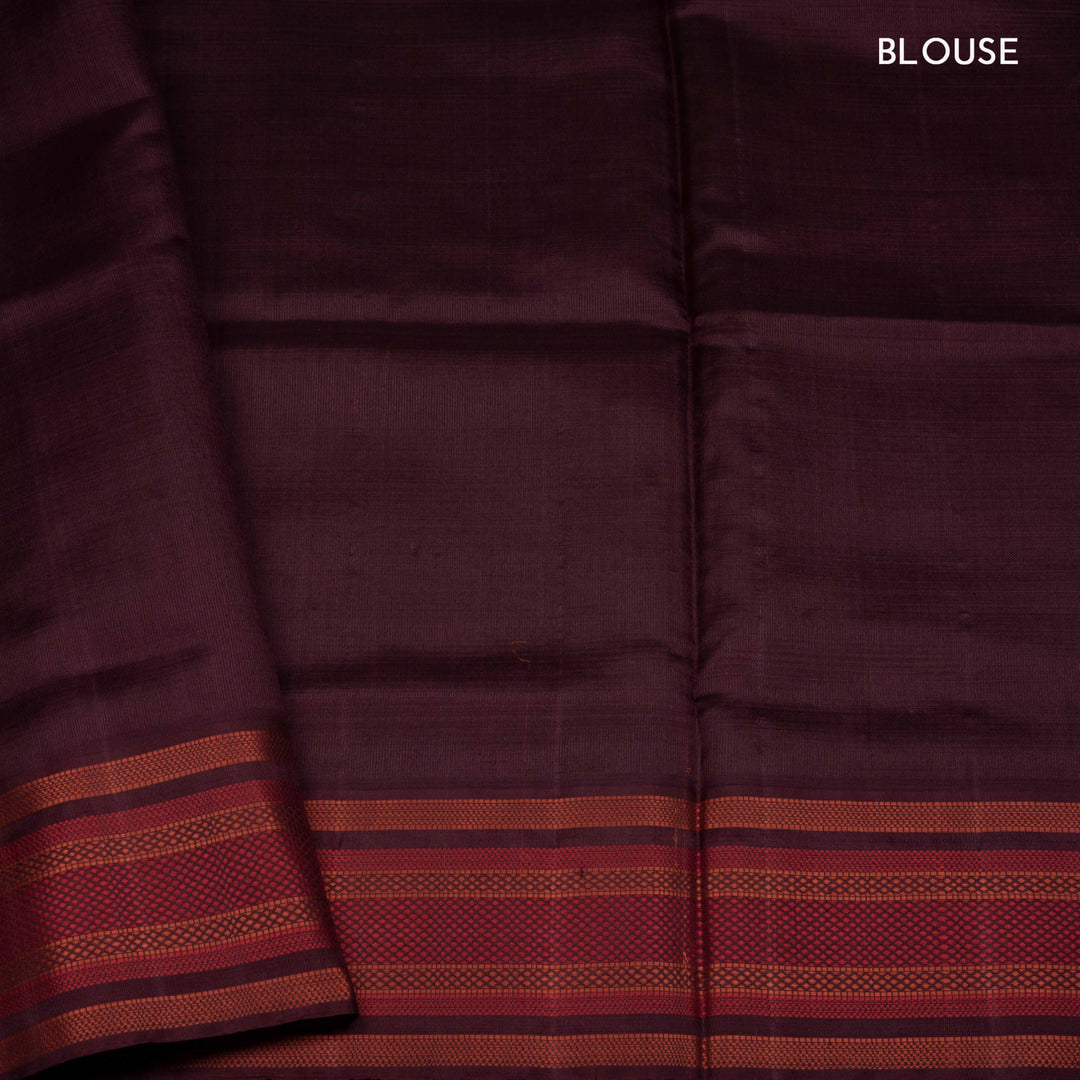 Mustard Gadwal silk saree with brown micro checks body, contrasting woven border with stripes and diamond patterns, brown pallu with temple motifs.