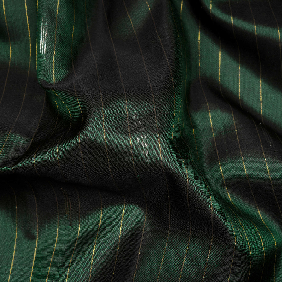 Bottle green Gadwal silk saree with gold zari stripes, peach border and temple design pallu
