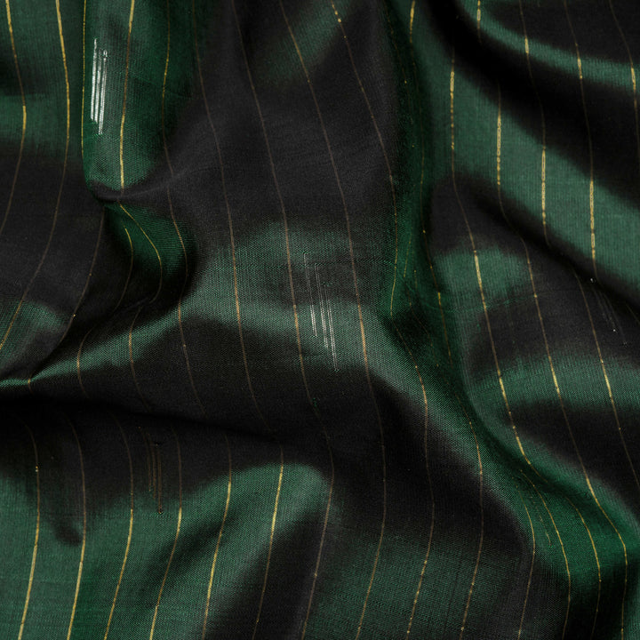 Bottle green Gadwal silk saree with gold zari stripes, peach border and temple design pallu