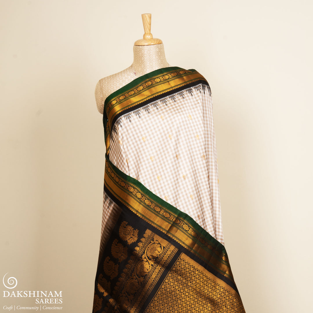 Off white Gadwal silk saree with small checks, dark green border and gold zari traditional motifs