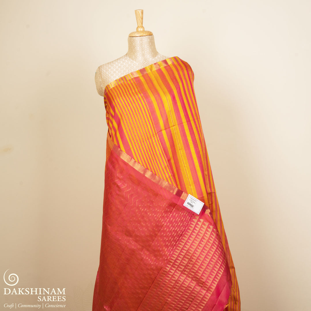 Multicolor Kora soft silk saree with alternating yellow and pink bands and gold zari lines, thin gold tissue border and pink pallu with chevron and triangle motifs.