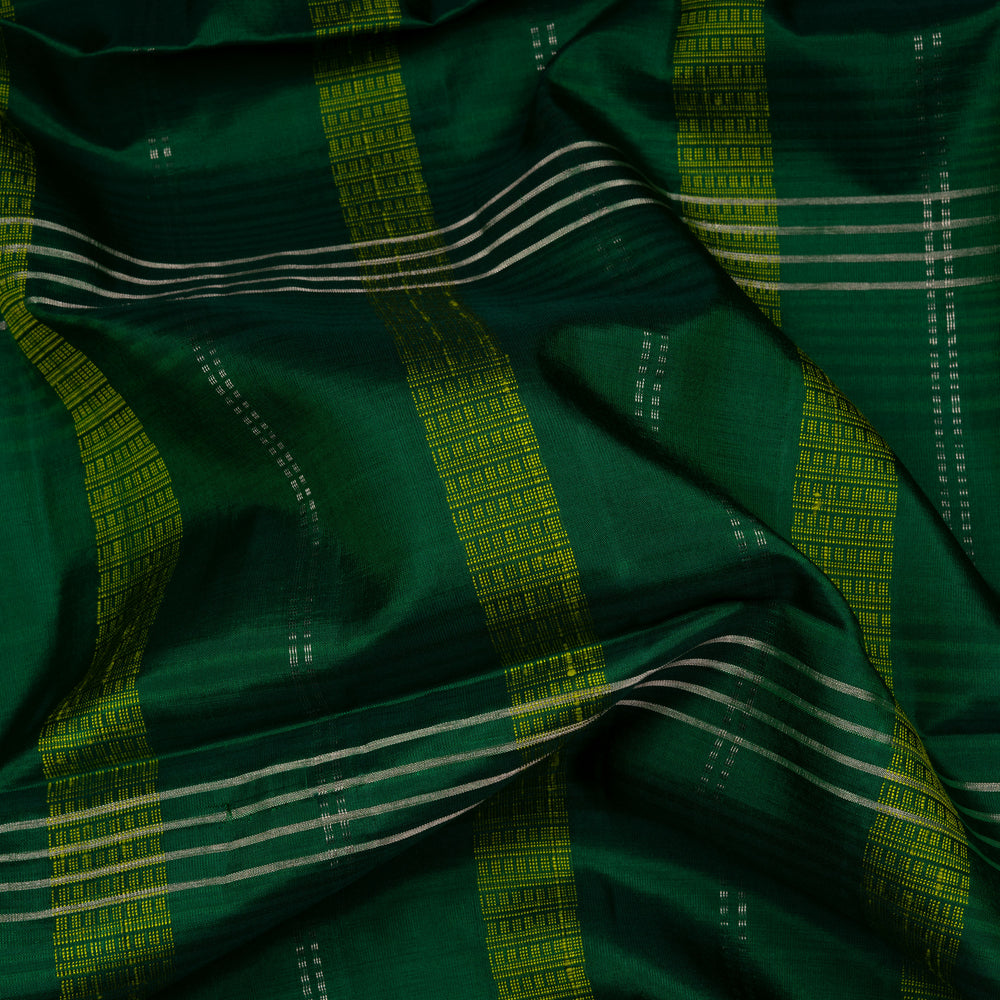 Green soft silk saree with lime yellow stripe and dash threadwork and silver zari lines, paired with a plain blouse with zari detailing.