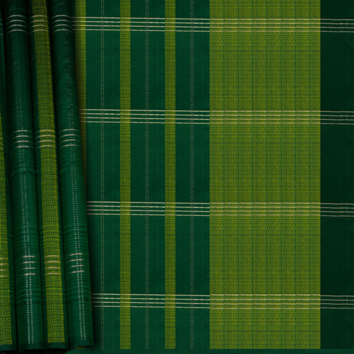 Green soft silk saree with lime yellow stripe and dash threadwork and silver zari lines, paired with a plain blouse with zari detailing.