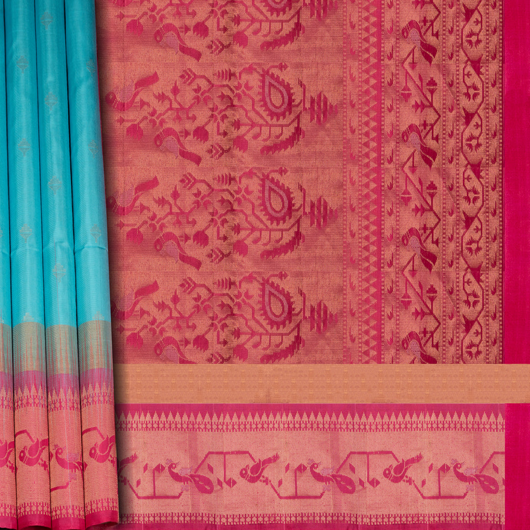 Light blue soft silk saree with silver butta allover, pink and gold zari border and pink pallu with bird and plant motifs.