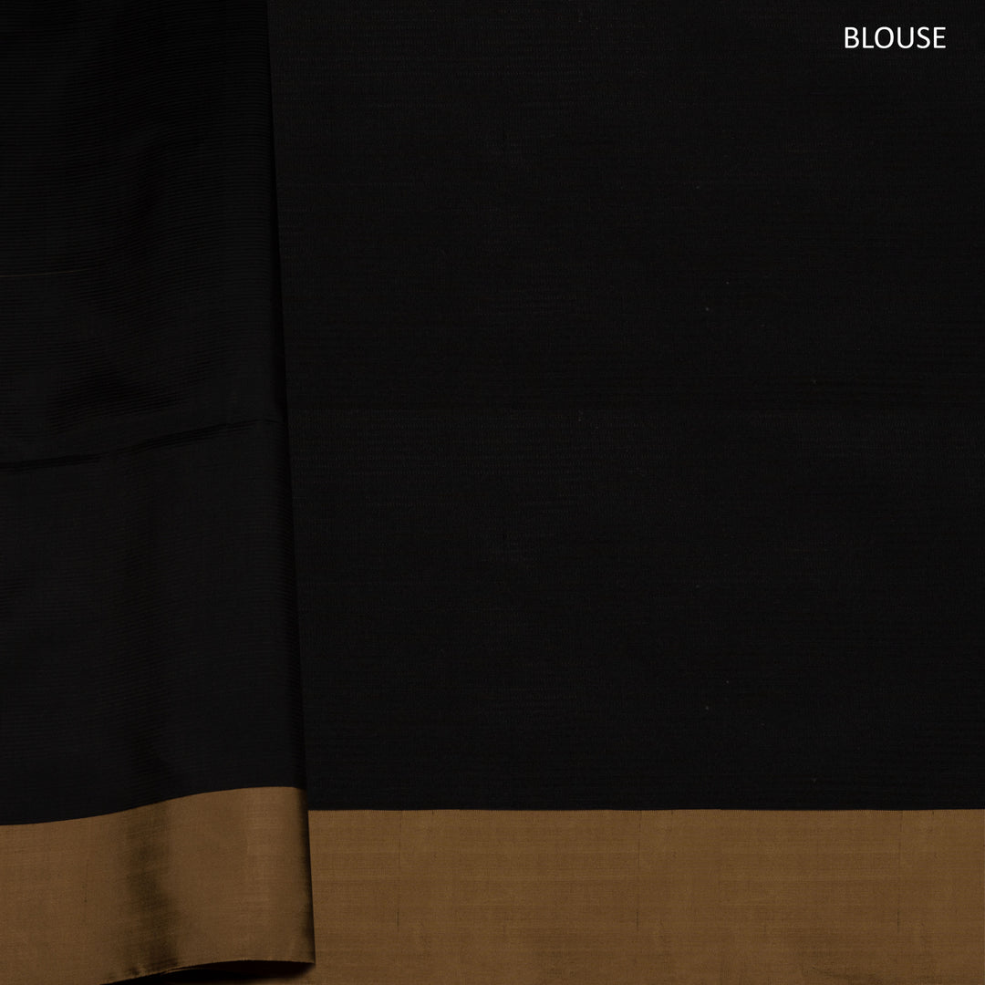 Beige soft silk saree with self-textured body, plain border and beige pallu with floral vine, lotus and chevron motifs in black and gold zari, paired with black blouse.