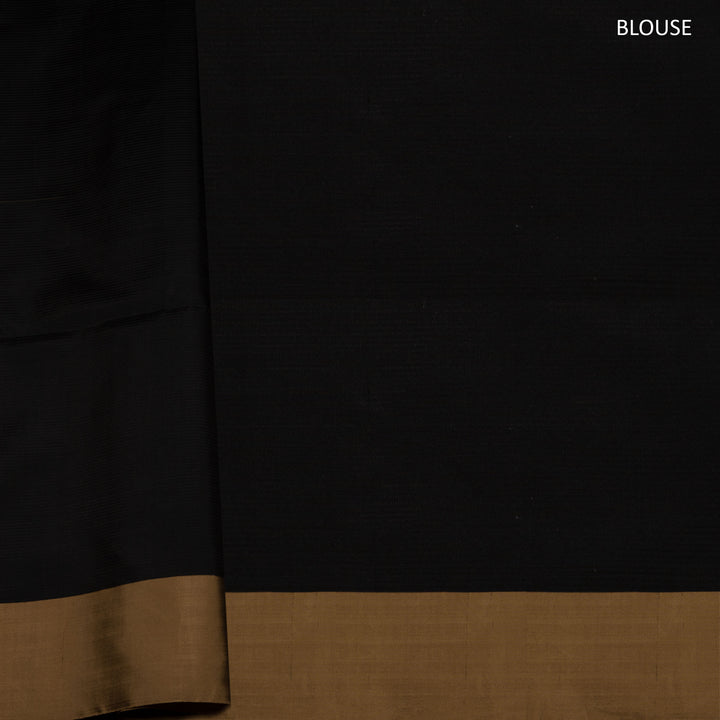 Beige soft silk saree with self-textured body, plain border and beige pallu with floral vine, lotus and chevron motifs in black and gold zari, paired with black blouse.