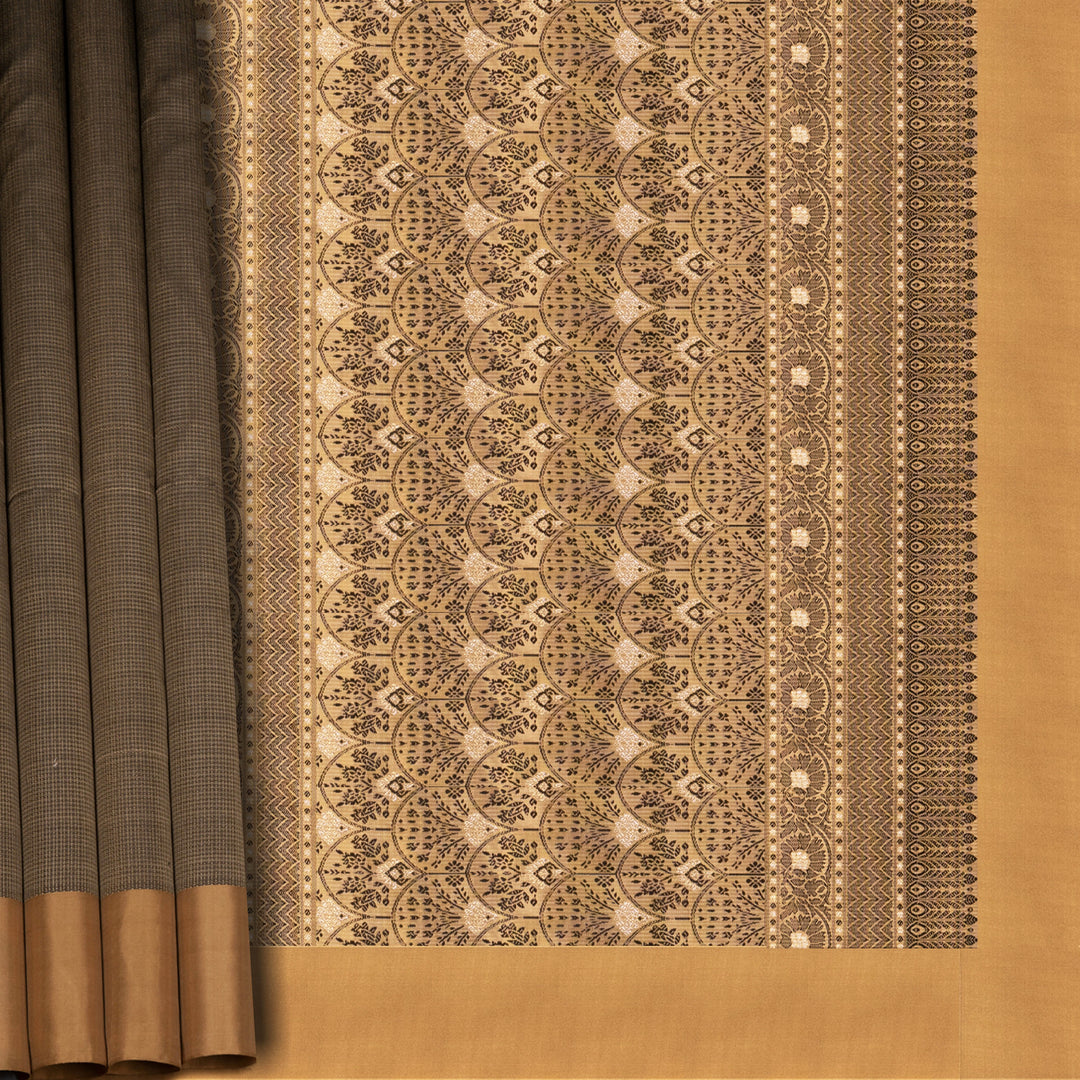 Beige soft silk saree with self-textured body, plain border and beige pallu with floral vine, lotus and chevron motifs in black and gold zari, paired with black blouse.