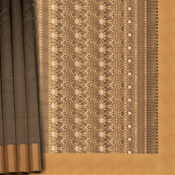 Beige soft silk saree with self-textured body, plain border and beige pallu with floral vine, lotus and chevron motifs in black and gold zari, paired with black blouse.