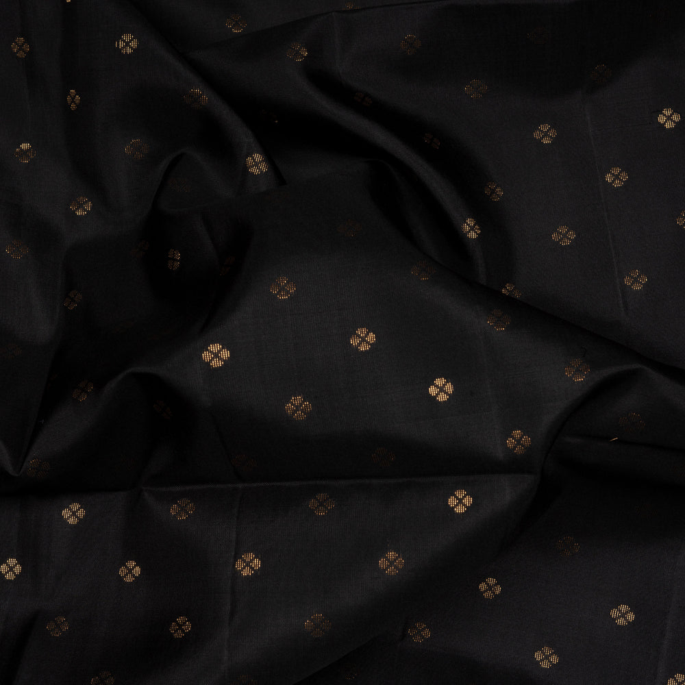 Black soft silk saree with small gold and silver zari buttas, floral border and blue contrast pallu with diamond and floral motifs.