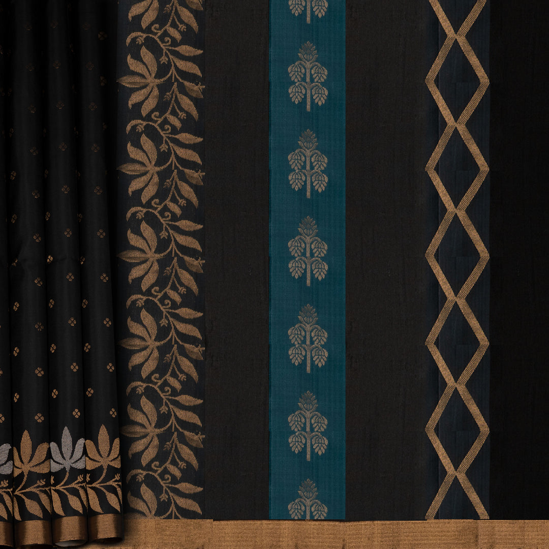 Black soft silk saree with small gold and silver zari buttas, floral border and blue contrast pallu with diamond and floral motifs.