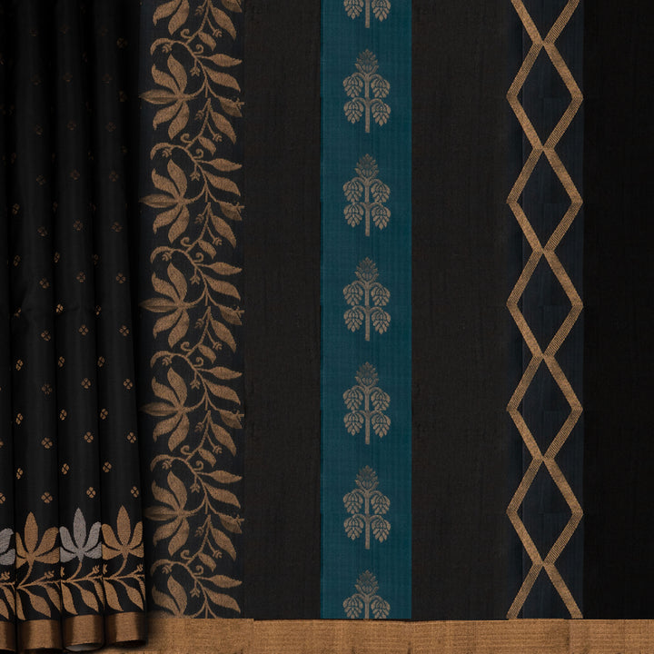 Black soft silk saree with small gold and silver zari buttas, floral border and blue contrast pallu with diamond and floral motifs.