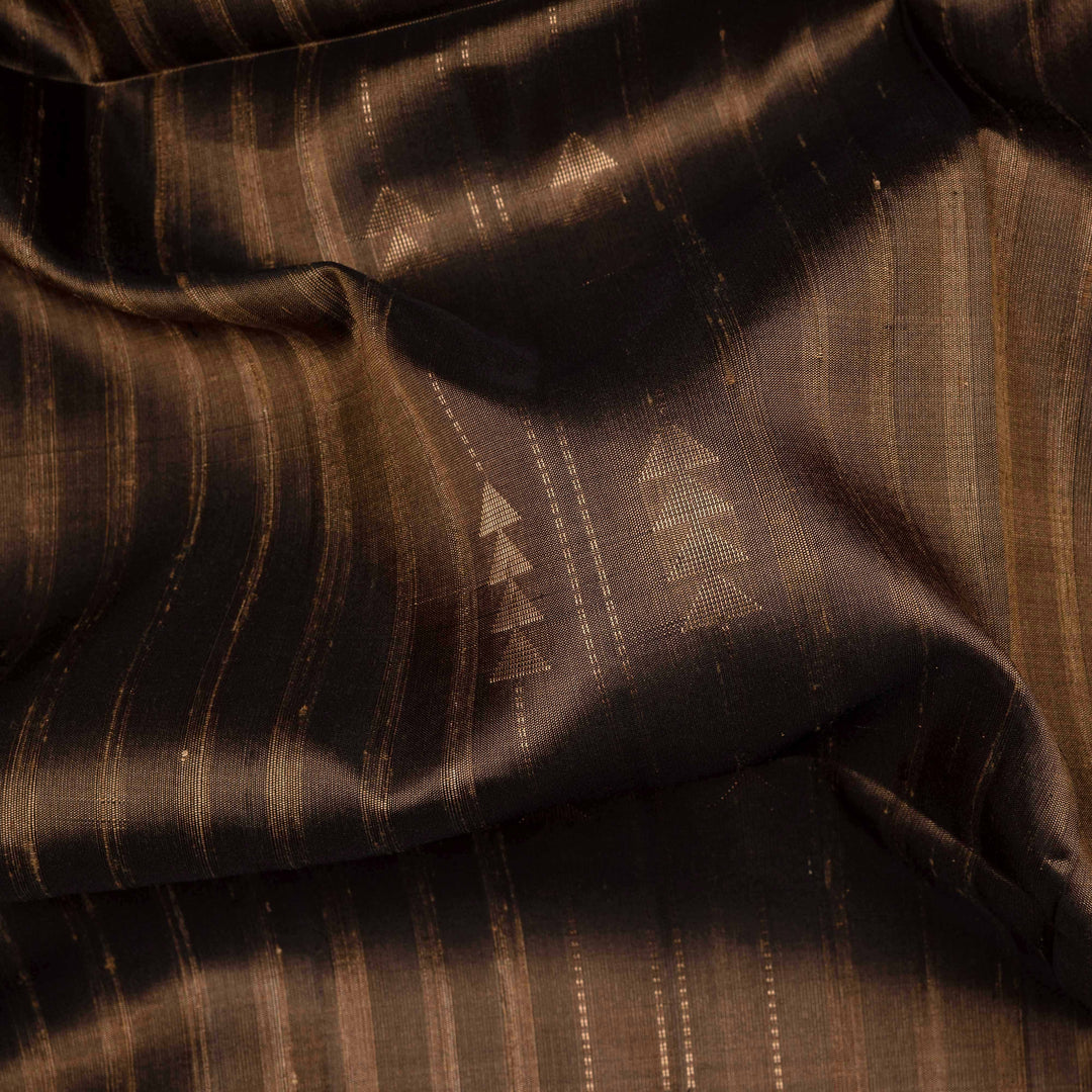 Brown soft silk saree with striped body and triangle motifs, gold tissue border and maroon black pallu with geometric patterns.