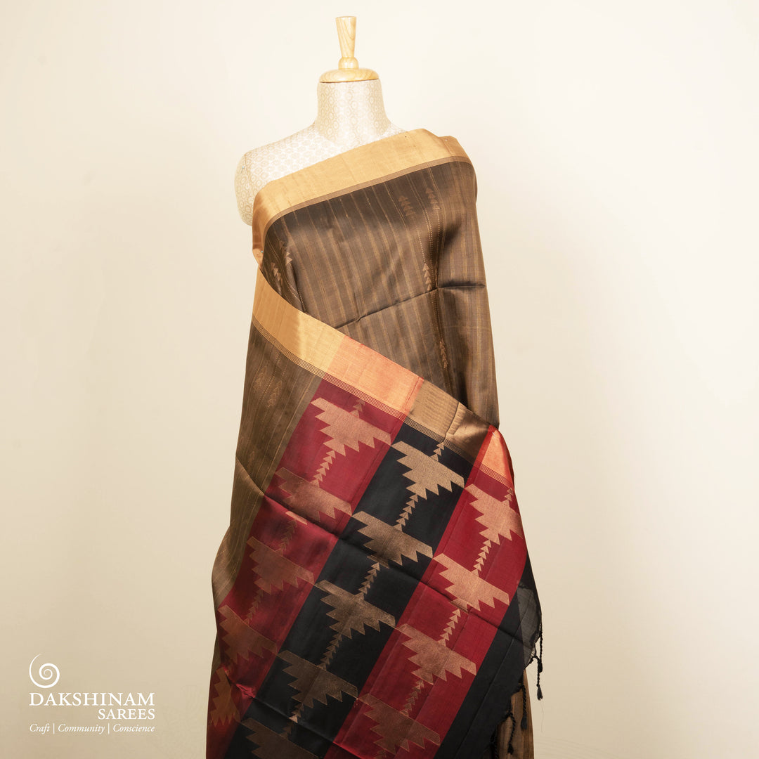 Brown soft silk saree with striped body and triangle motifs, gold tissue border and maroon black pallu with geometric patterns.
