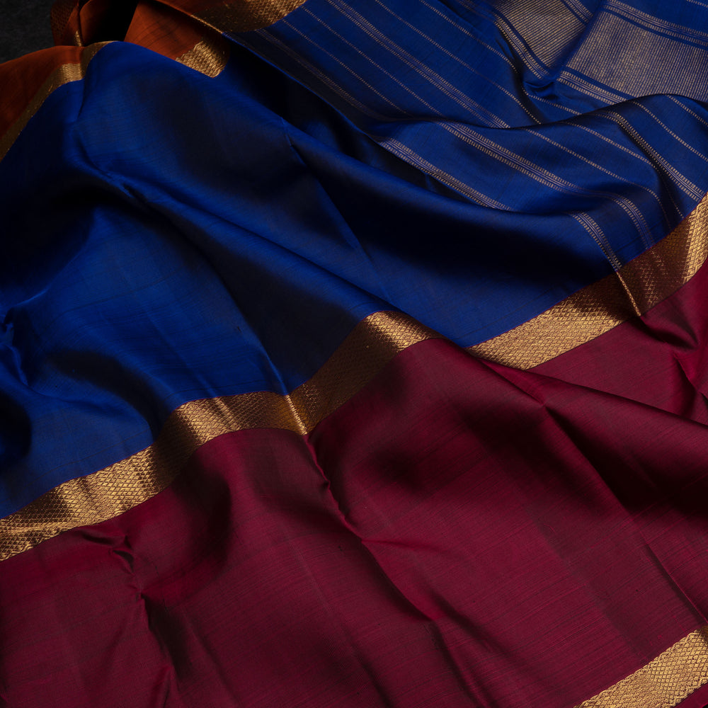 Blue Kanchipuram silk saree with two different gold zari borders featuring diamond and veldhari motifs and zari-lined pallu.