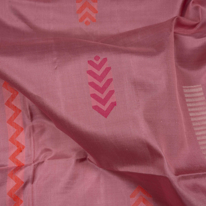 Light pink borderless soft silk saree with dotted lines, geometric square and rectangle patterns with silver zari and striped pallu.