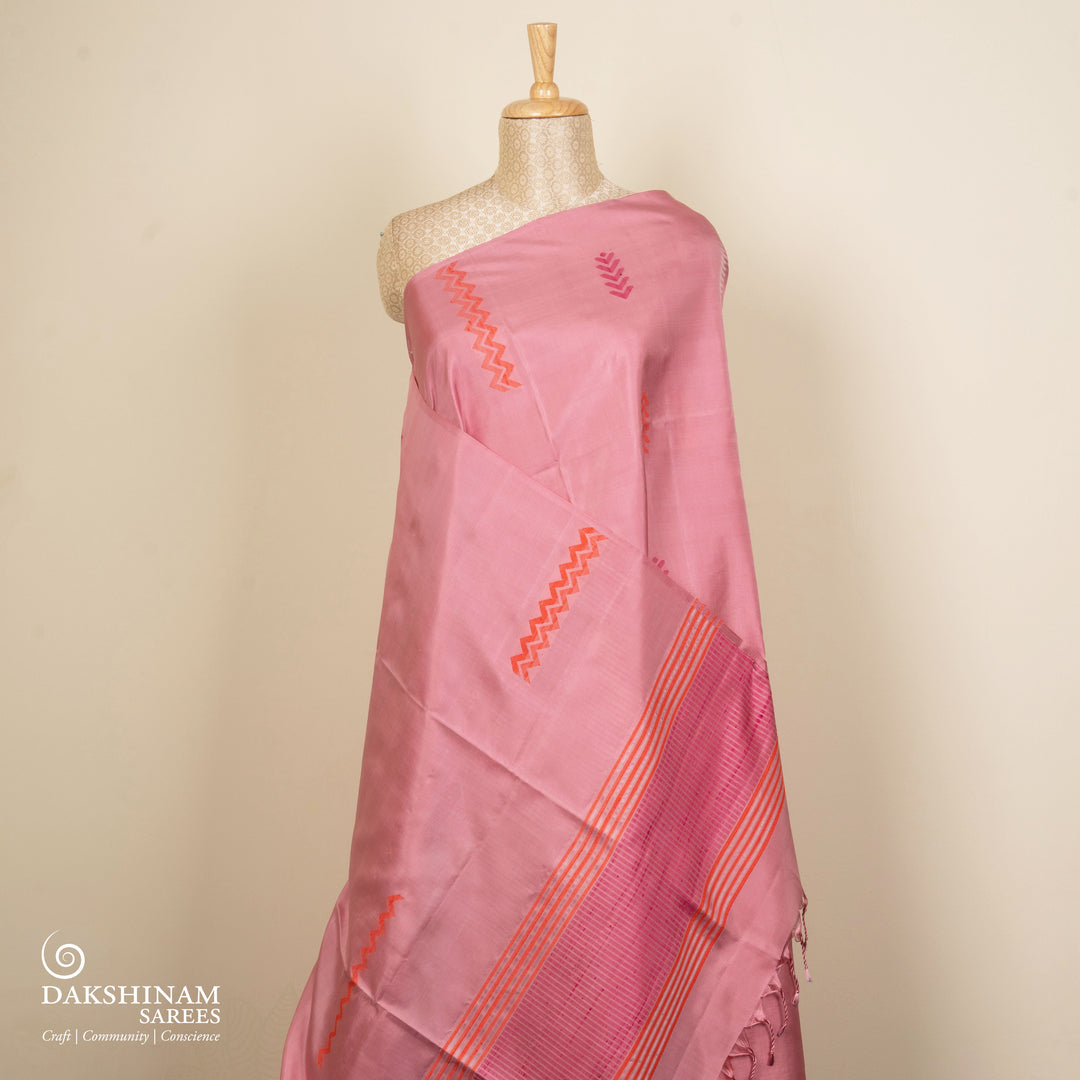 Light pink borderless soft silk saree with dotted lines, geometric square and rectangle patterns with silver zari and striped pallu.