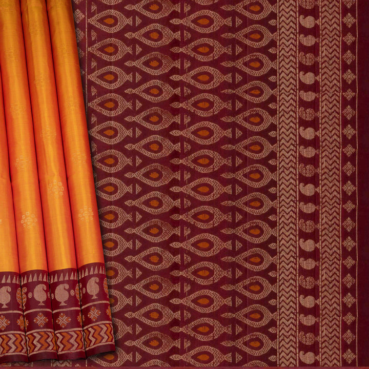 Orange soft silk saree with floral butta body, maroon border with paisley and chevron motifs, and maroon pallu with diamond floral patterns.