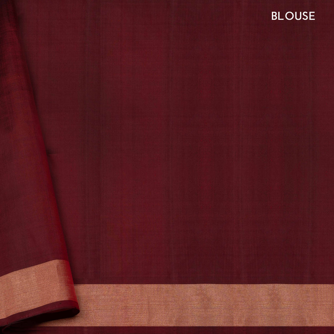 Orange soft silk saree with floral butta body, maroon border with paisley and chevron motifs, and maroon pallu with diamond floral patterns.