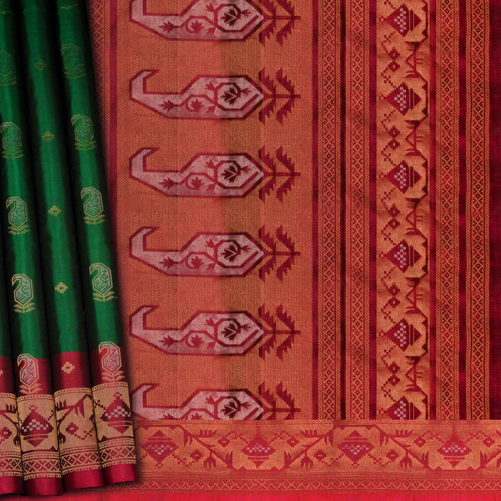 Green soft silk saree with paisley leaf buttas in gold and silver zari, maroon Paithani style border with floral vines and maroon pallu with paisley motifs.