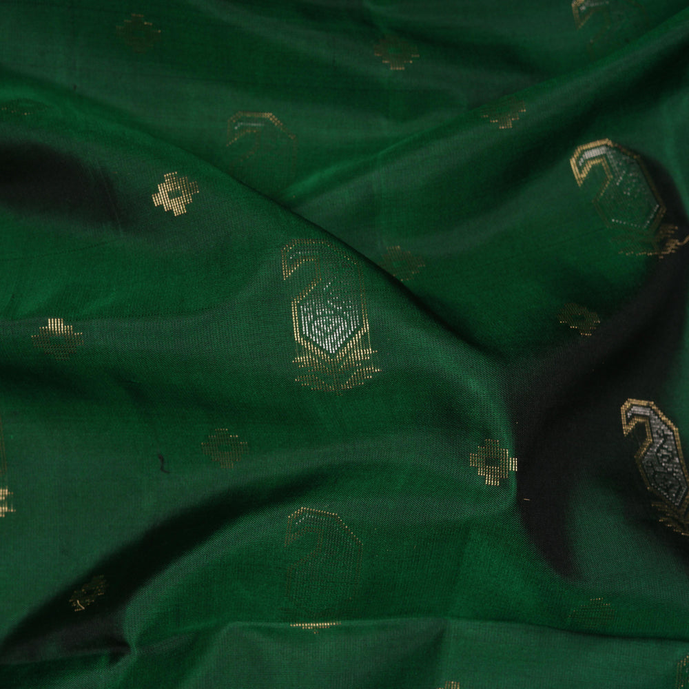 Green soft silk saree with paisley leaf buttas in gold and silver zari, maroon Paithani style border with floral vines and maroon pallu with paisley motifs.