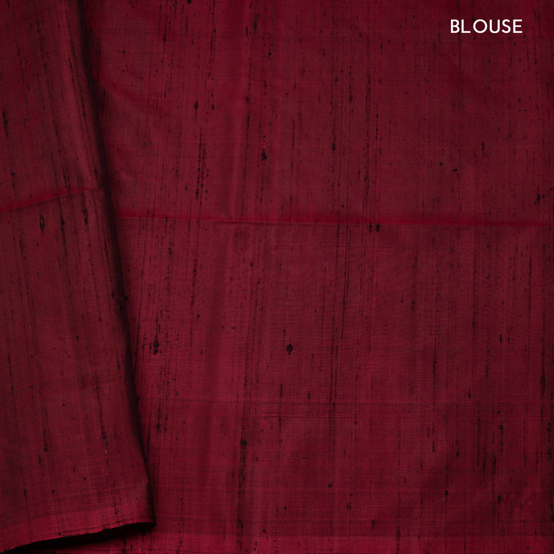 Green soft silk saree with paisley leaf buttas in gold and silver zari, maroon Paithani style border with floral vines and maroon pallu with paisley motifs.