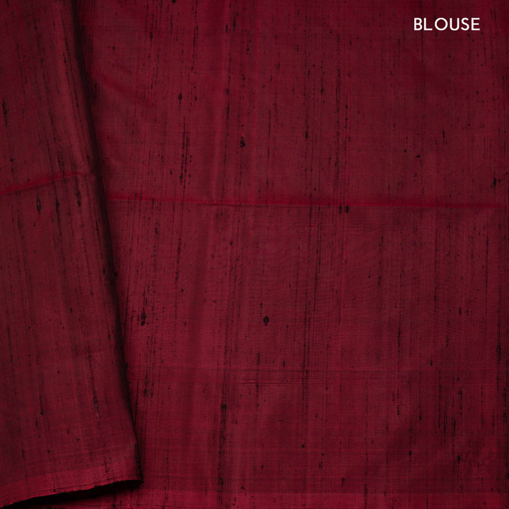 Green soft silk saree with paisley leaf buttas in gold and silver zari, maroon Paithani style border with floral vines and maroon pallu with paisley motifs.