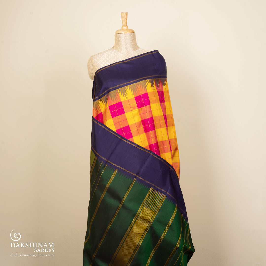 Multicolor handwoven Kanjivaram silk saree with checkered body, korvai thazampoo motifs, green rettapet border, and temple design pallu, paired with green blouse.