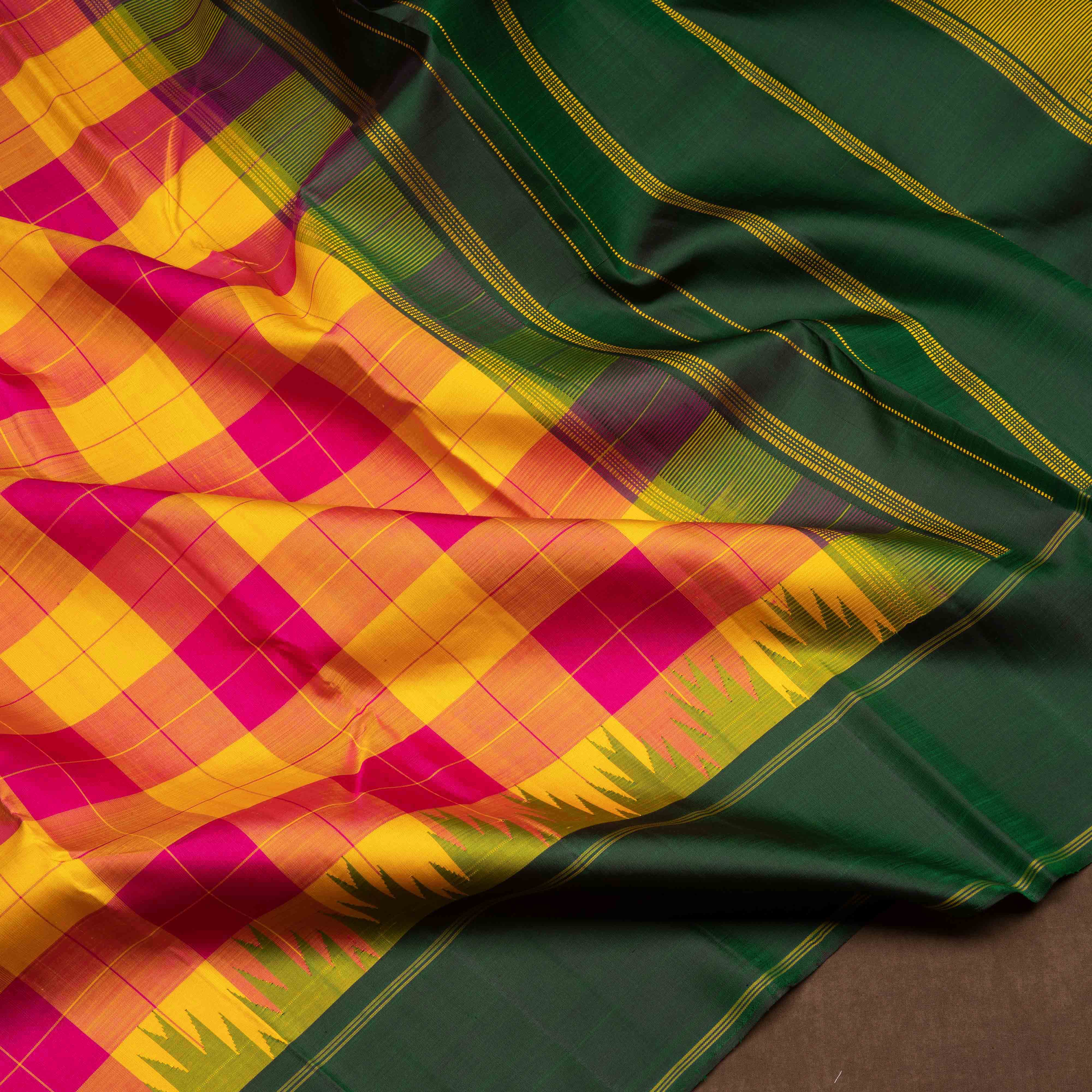 Multicolor handwoven Kanjivaram silk saree with checkered body, korvai thazampoo motifs, green rettapet border, and temple design pallu, paired with green blouse.