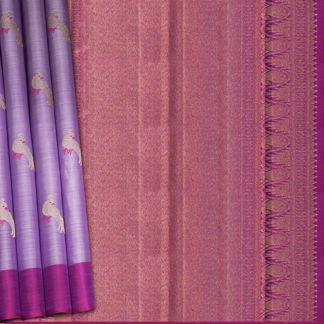 Purple handwoven Kanjivaram silk saree with meenakari parrot motifs, magenta border, detailed pallu with mango, thazampoo, and temple designs, paired with magenta blouse.