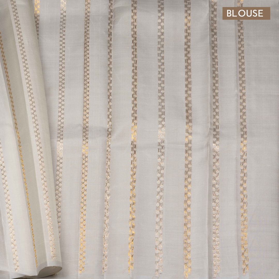 Pink handwoven Kanjivaram silk saree with vertical annam and chakram zari buttas, grey pallu with floral and traditional motifs, paired with grey blouse.