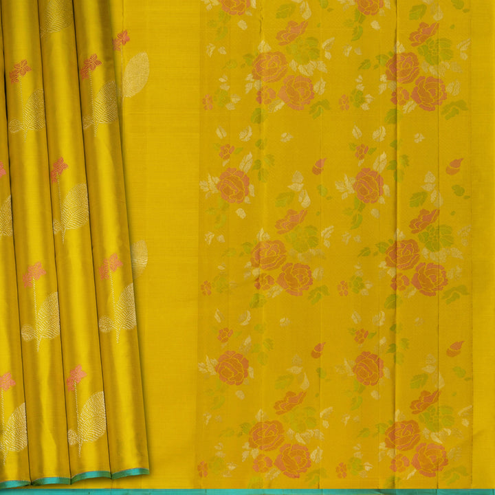 Lime green handwoven Kanjivaram silk saree with floral and leaf motifs, rose design pallu, borderless style, paired with light blue blouse with silver zari stripes.