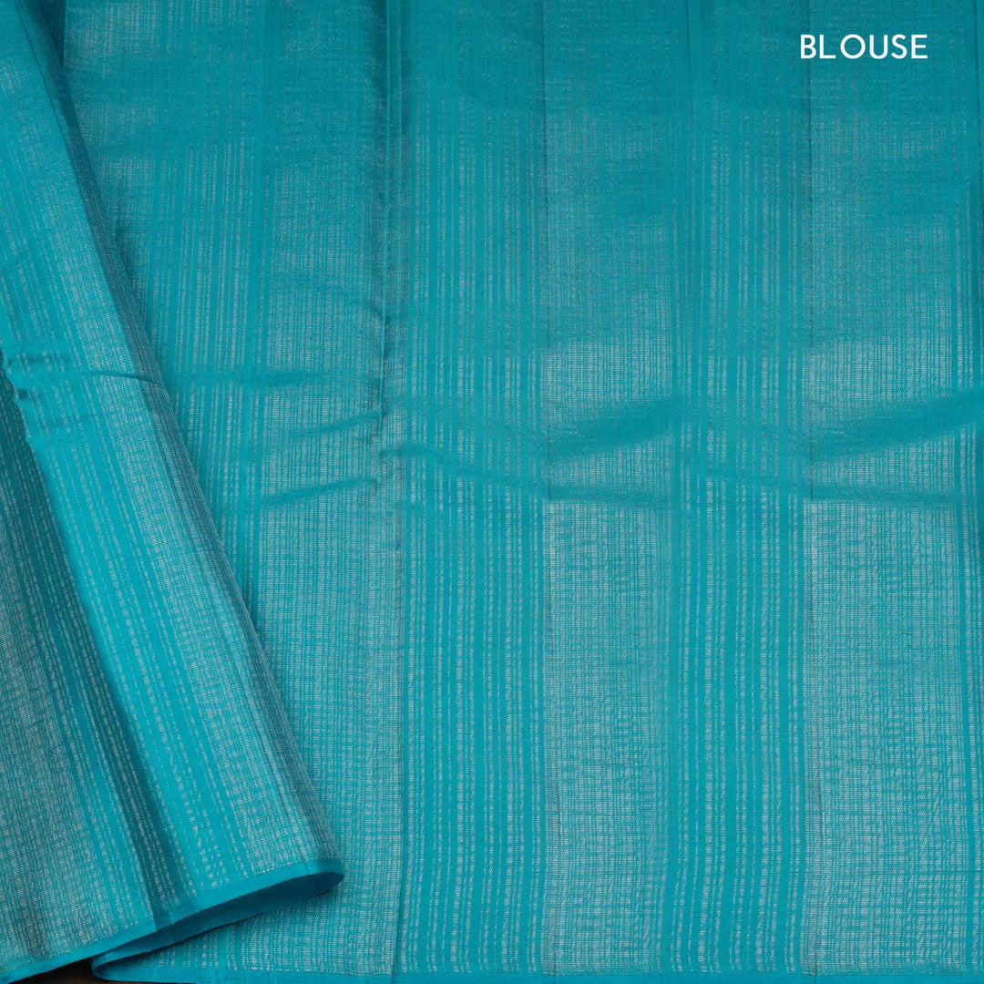 Lime green handwoven Kanjivaram silk saree with floral and leaf motifs, rose design pallu, borderless style, paired with light blue blouse with silver zari stripes.