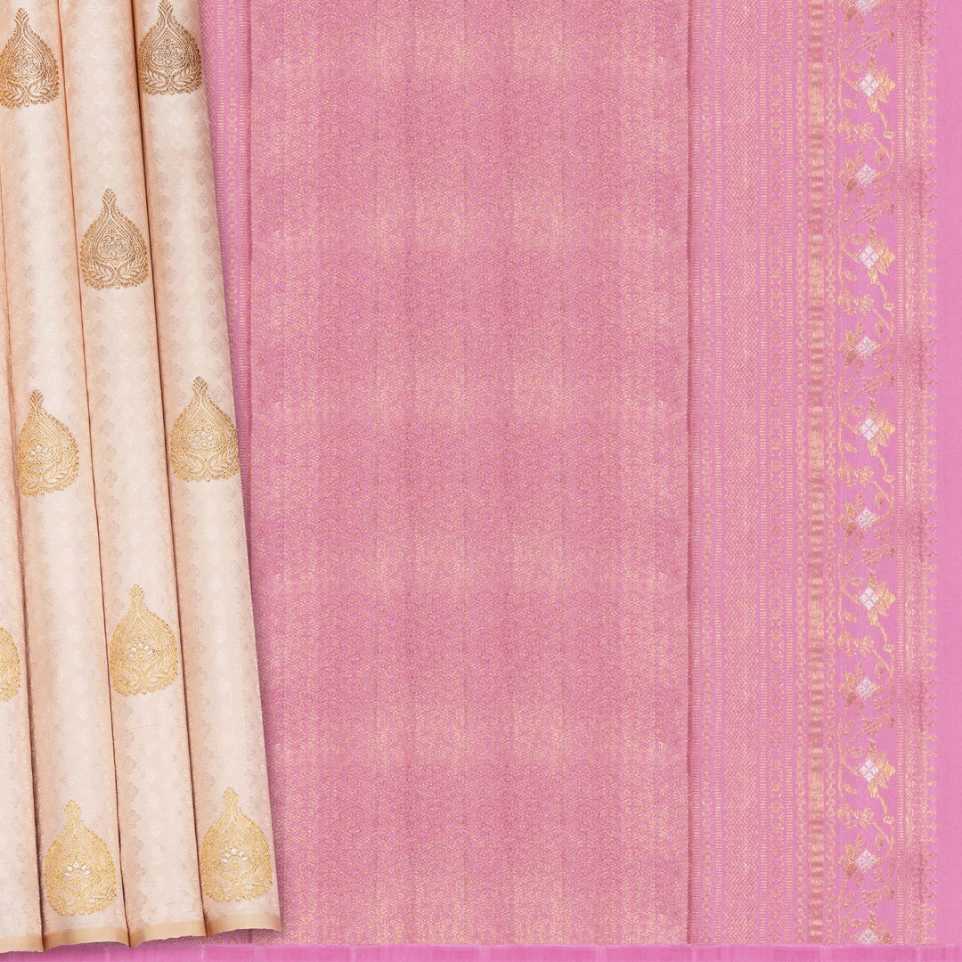Beige handwoven Kanjivaram silk saree with self design and gold zari floral motifs, lavender border and pallu with chevron and floral patterns, paired with lavender blouse.