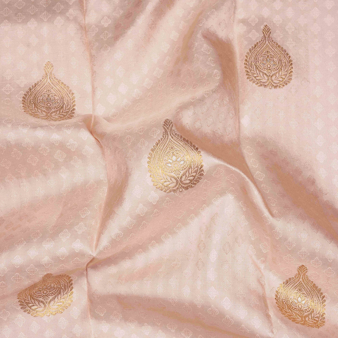 Beige handwoven Kanjivaram silk saree with self design and gold zari floral motifs, lavender border and pallu with chevron and floral patterns, paired with lavender blouse.