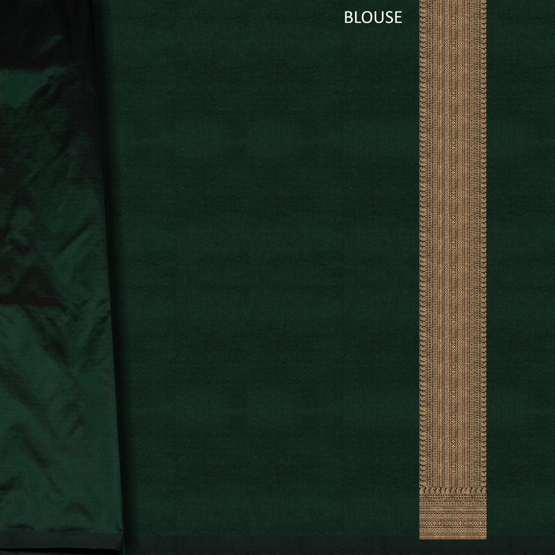 Dark green Banarasi silk saree with all-over gold brocade featuring round and diamond buttas, intricate zari border with chevron and traditional motifs, paired with a plain dark green blouse.