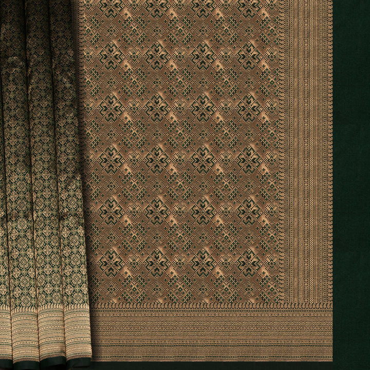 Dark green Banarasi silk saree with all-over gold brocade featuring round and diamond buttas, intricate zari border with chevron and traditional motifs, paired with a plain dark green blouse.
