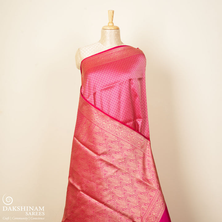 Pink Banarasi silk saree with gold brocade, diamond and vaira mookuthi buttas, paisley border with dotted and malli moggu design and matching pallu.