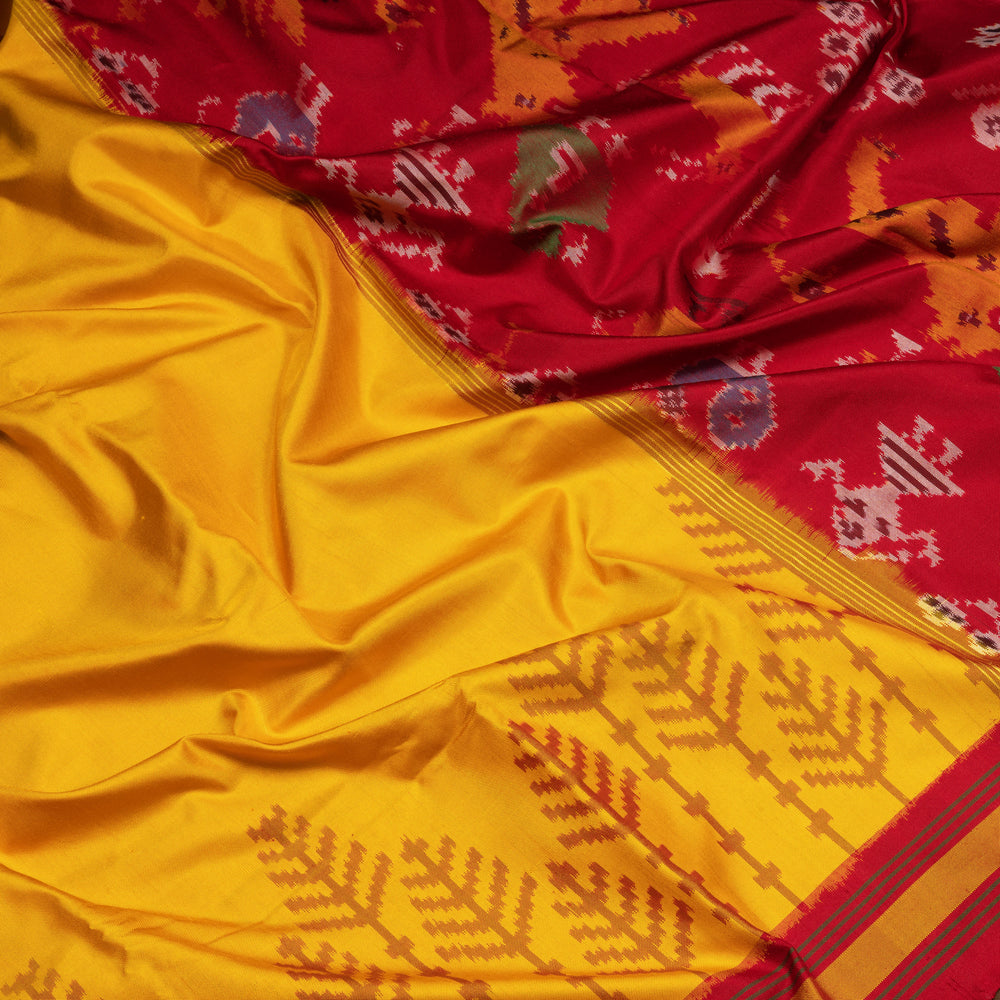 Yellow Ikat silk saree with red border accents, green and yellow border lines and red pallu with animal and human motifs, paired with red ikat blouse.