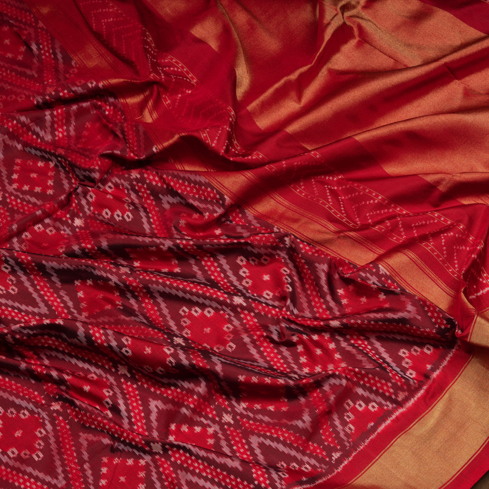 Red Pochampally Ikat silk saree with diamond motifs, red and gold zari border, and temple design pallu with arrow patterns, paired with plain red blouse with zari border.