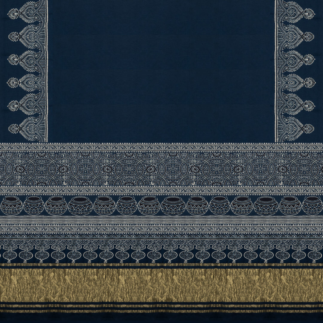 Blue handwoven modal silk cotton saree with plain blue body, Ajrakh printed border, gold zari pallu, paired with a blue Ajrakh design blouse.