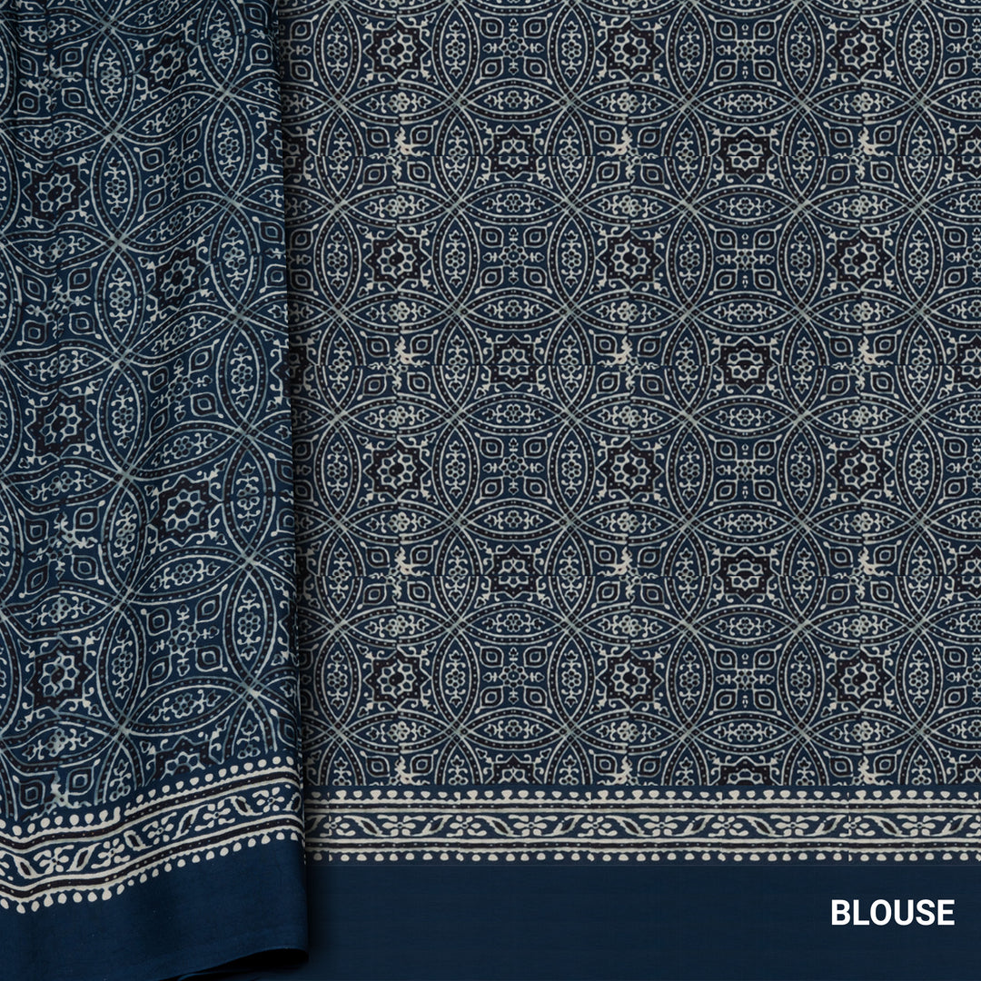 Blue handwoven modal silk cotton saree with plain blue body, Ajrakh printed border, gold zari pallu, paired with a blue Ajrakh design blouse.