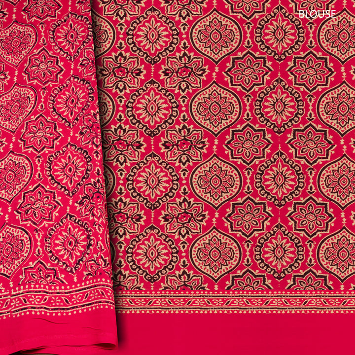Pink handwoven modal silk  saree with plain pink body, Ajrakh printed border, gold zari pallu, paired with a pink Ajrakh design blouse.