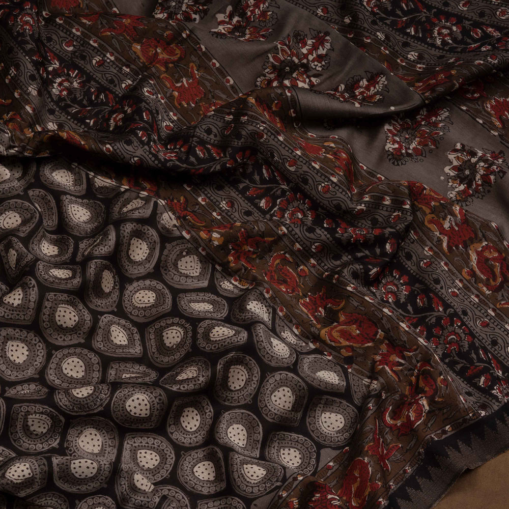 Grey handwoven Chanderi silk saree with Ajrakh print, gicha temple border, floral pallu design, paired with grey blouse with floral vines.