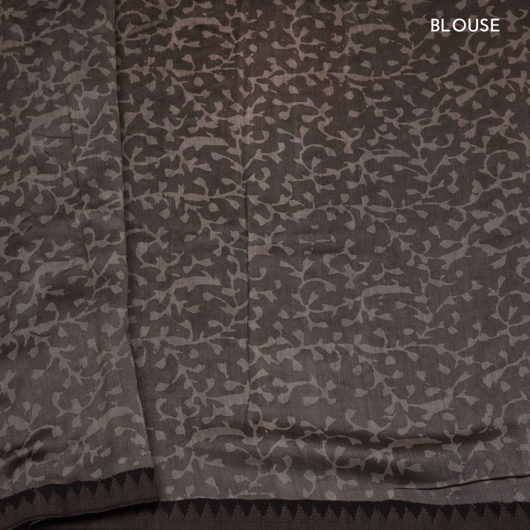 Grey handwoven Chanderi silk saree with Ajrakh print, gicha temple border, floral pallu design, paired with grey blouse with floral vines.