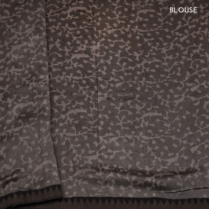 Grey handwoven Chanderi silk saree with Ajrakh print, gicha temple border, floral pallu design, paired with grey blouse with floral vines.