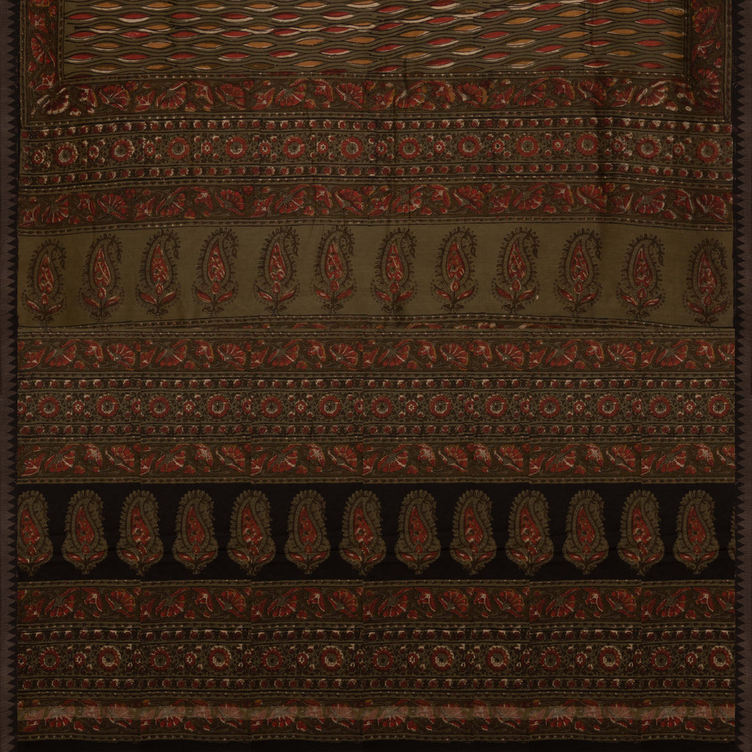 Army green handwoven Chanderi silk saree with yellow and red Ajrakh print, gicha temple border, floral pallu design, paired with green blouse with chevron lines.