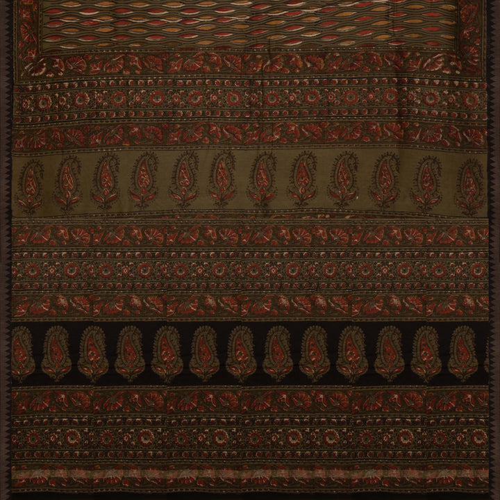 Army green handwoven Chanderi silk saree with yellow and red Ajrakh print, gicha temple border, floral pallu design, paired with green blouse with chevron lines.